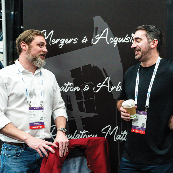 Two men talking at NAPE Summit