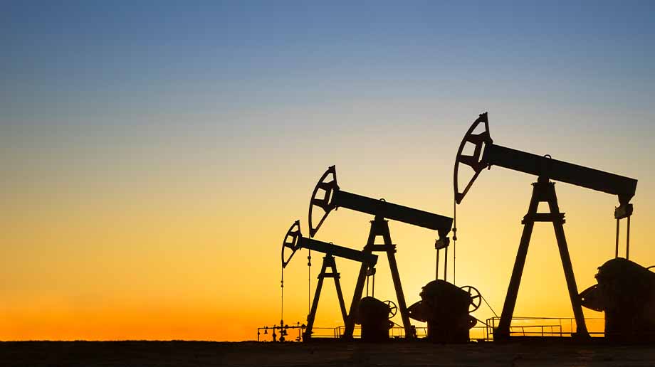 Three oil pump silhouettes at sunset