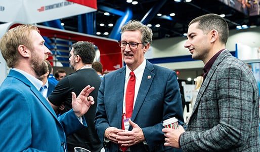 Oliva Gibbs team members talking at the NAPE summit