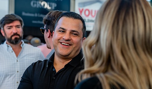 man smiling in conversation at a professional event