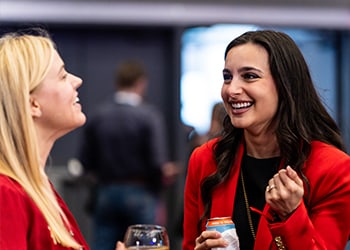 Smiling women in conversation at NAPE Summit