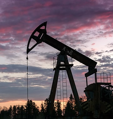 Oil pump silhouette against night sky