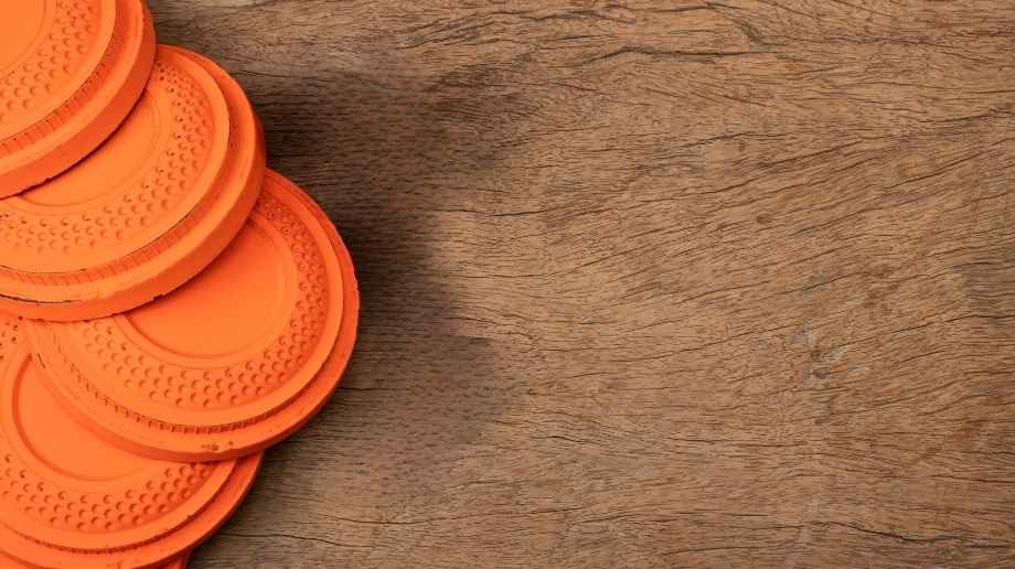 Orange sporting clays on brown wood table