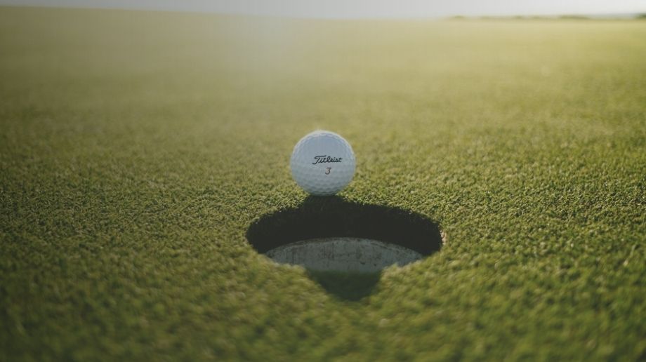 Golf ball at the edge of a golf hole