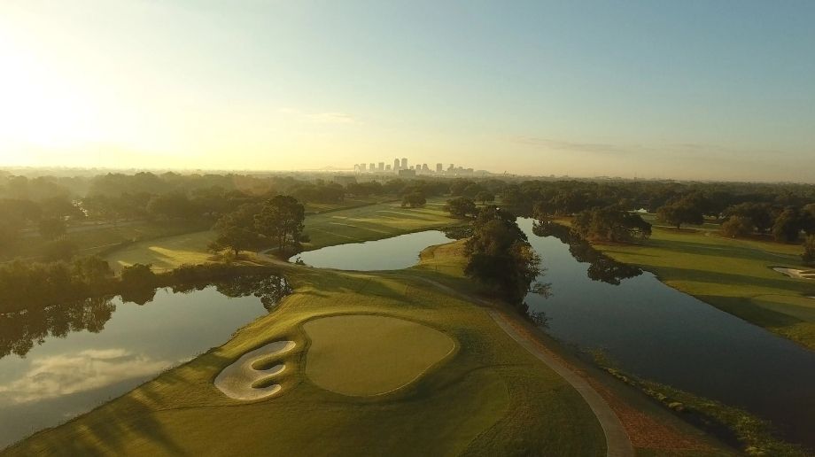 Golf course with ponds and city in the distance