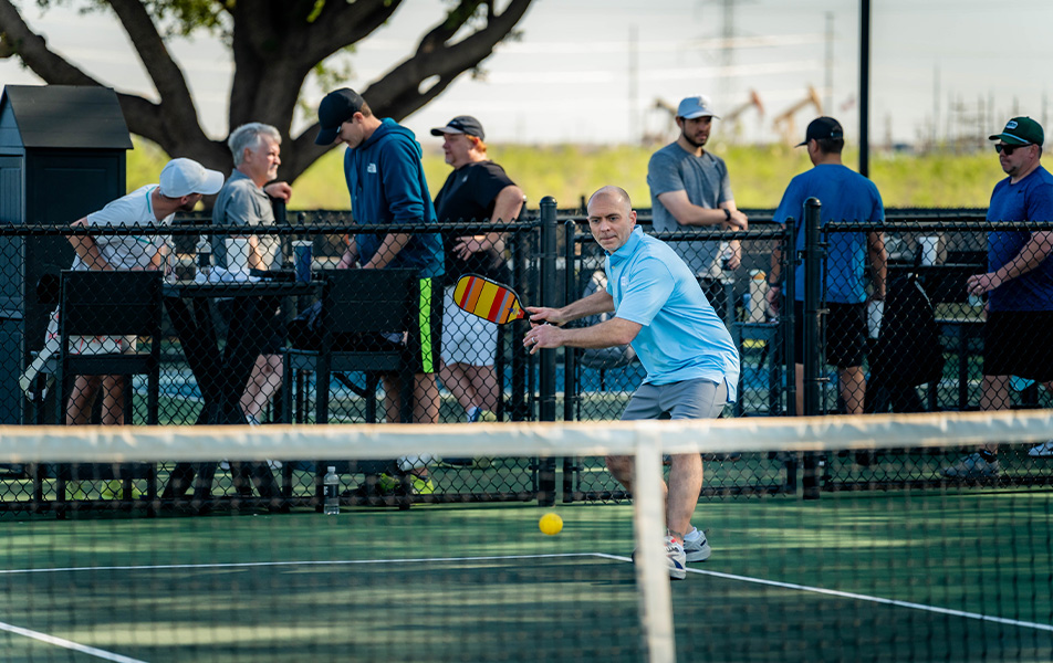 Man playing pickleball outdoors