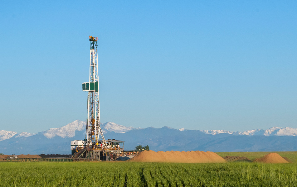 Drilling rig on the Colorado Plains with the Rocky Mountains in the background