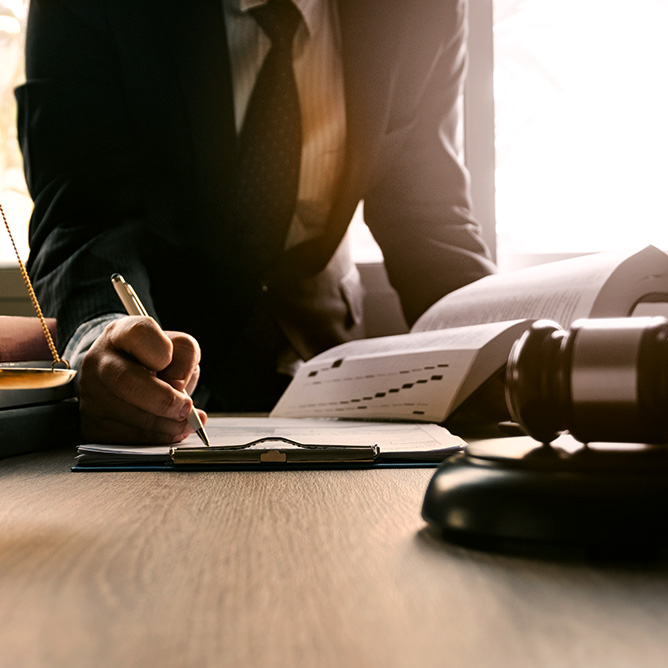 Male lawyer working with contract papers in an office