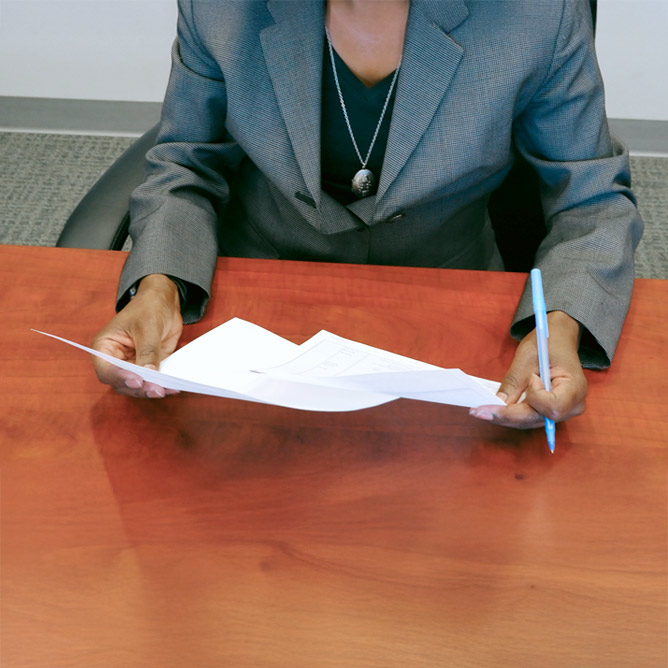 Female attorney sitting at table with contract