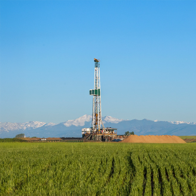 Drilling rig on the Colorado Plains with the Rocky Mountains in the background